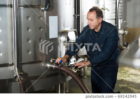 Man estimates operation of equipment Man estimates operation of equipment 69142045