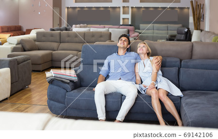 couple who are choosing sofa-transformer couple who are choosing sofa-transformer 69142106