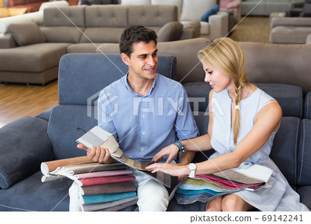Boyfriend and girlfriend are choosing color of new sofa Boyfriend and girlfriend are choosing color of new sofa 69142241