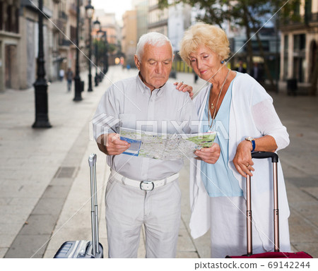 travellers with suitcases visiting sights of European city travellers with suitcases visiting sights of European city 69142244