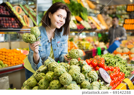 Woman choosing fruit Woman choosing fruit 69142288