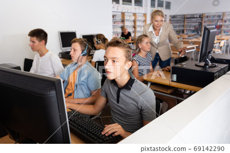 Boys and girls using computers in IT room Boys and girls using computers in IT room 69142290