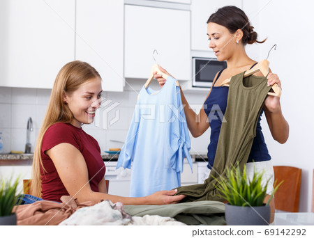 Girls talking and showing each other clothes 69142292
