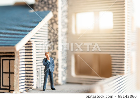 Miniature people stay at home doing self-quarantine to avoid coronavirus 69142866