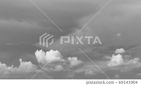 Dramatic dark heavy rain clouds flying passing rolling or moving in sky on monsoon evening in Mid June. Dramatic dark heavy rain clouds flying passing rolling or moving in sky on monsoon evening in Mi 69143904