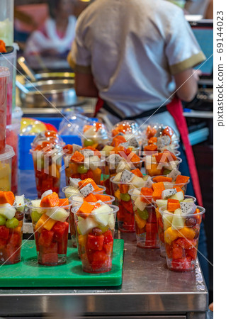 Colorful mixed fruit cups in dessert store's kitchen Colorful mixed fruit cups in dessert store's kitchen 69144023
