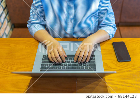 High angle view photo of woman hand typing laptop keyboard 69144128