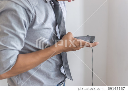 Man in shirt text message on phone Man in shirt text message on phone 69145167