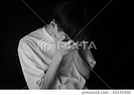 Men covering their faces by hand 69145890