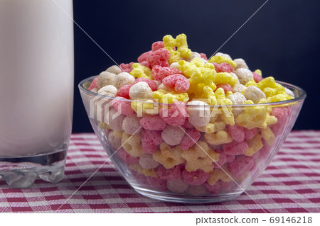 Colored light snacks. Breakfast in a plate and a glass of milk. Colored light snacks. Breakfast in a plate and a glass of milk. 69146218