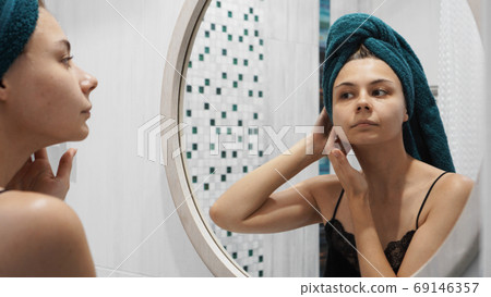 Young woman has problems with skin on the face 69146357