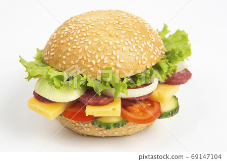 Hamburger with vegetables and sausage on a white background. Fas Hamburger with vegetables and sausage on a white background. Fas 69147104