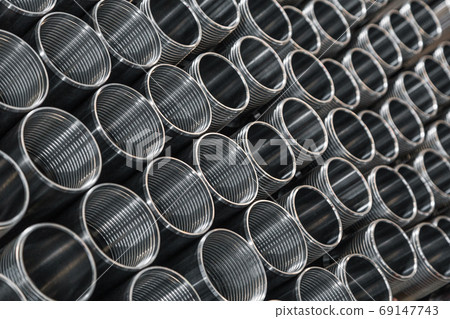 Pattern of metal cylinders stand on table at factory. Steel products to automotive industry. Billet obtained on lathe from steel and cast iron. Circular precision steel parts arranged in rows Pattern of metal cylinders stand on table at factory. Steel products to automotive industry. Billet obtained on lathe from steel and cast iron. Circular precision steel parts arranged in rows 69147743
