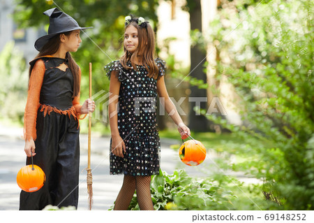 Girls in Halloween costumes 69148252