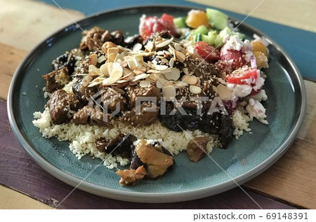 couscous lamb stove with salad on a plate on a table 69148391