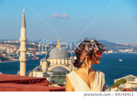 Eurasian woman standing at the roof with bosphorus background in Istanbul, Turkey 69148421