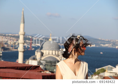 Eurasian woman standing at the roof with bosphorus background in Istanbul, Turkey Eurasian woman standing at the roof with bosphorus background in Istanbul, Turkey 69148422
