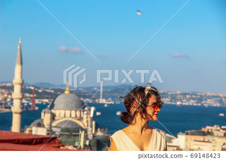 Eurasian woman standing at the roof with bosphorus background in Istanbul, Turkey 69148423