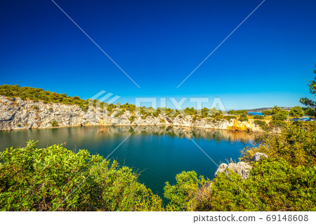 The Zmajevo oko, Dragon's Eye lake at sunny day. The Zmajevo oko, Dragon's Eye lake at sunny day. 69148608