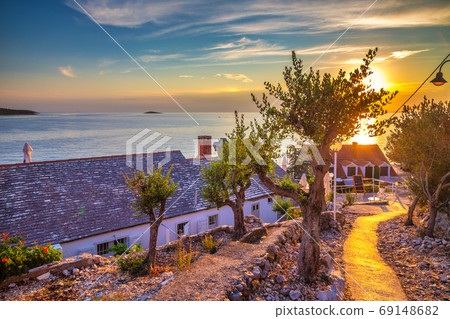 Sidewalk by the sea at sunset in Primosten town. Sidewalk by the sea at sunset in Primosten town. 69148682