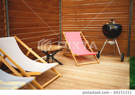 recreation area in the yard of the house: chairs, barbecue, table 69151151