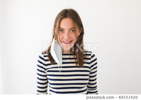 Happy young woman with medical mask Happy young woman with medical mask 69151420