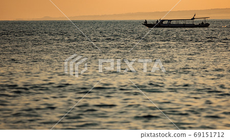 small boat floats on the water against the background of mountains small boat floats on the water against the background of mountains 69151712