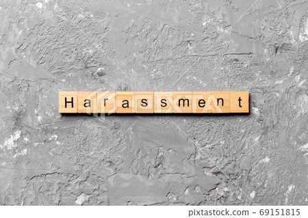 harassment word written on wood block. harassment text on cement table for your desing, concept harassment word written on wood block. harassment text on cement table for your desing, concept 69151815