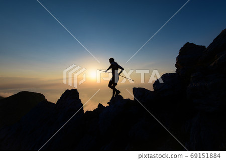 Sky runner in silhouette at sunset among the rocks 69151884