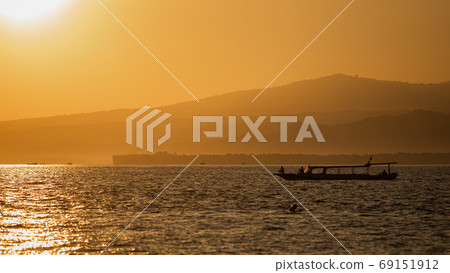 small boat floats on the water against the background of mountains 69151912