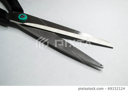 Open shears or scissors isolated on white background. Shot of close up view on cutting edge of office instrument to work with paper. 69152124