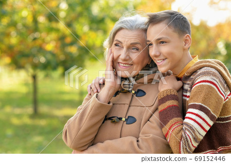 Happy grandmother and grandson posing in park 69152446
