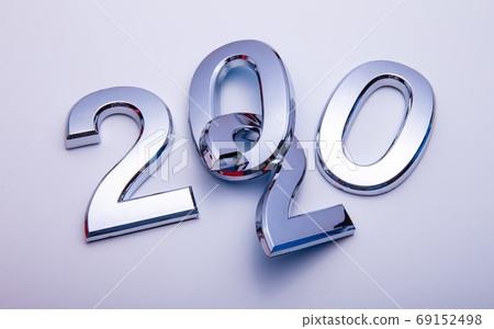 Happy New Year 2020. Symbol from number 2020 on bright background. Silver letters in the form of numbers 2020. Happy New Year 2020. Symbol from number 2020 on bright background. Silver letters in the form of numbers 2020. 69152498