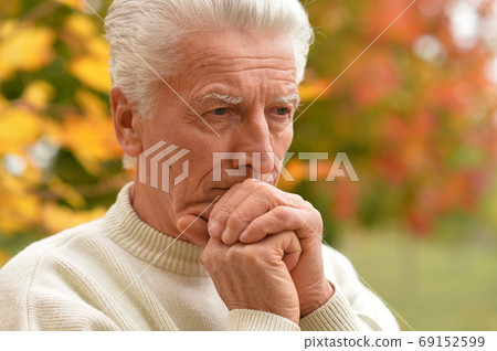 Close up portrait of sad senior man in park Close up portrait of sad senior man in park 69152599