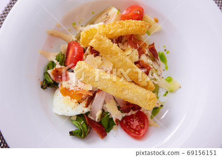 Plate with fresh caesar salad. Shallow dof. Plate with fresh caesar salad. Shallow dof. 69156151