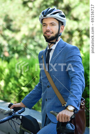 Happy bearded businessman in helmet with bicycle. Happy bearded businessman in helmet with bicycle. 69156717