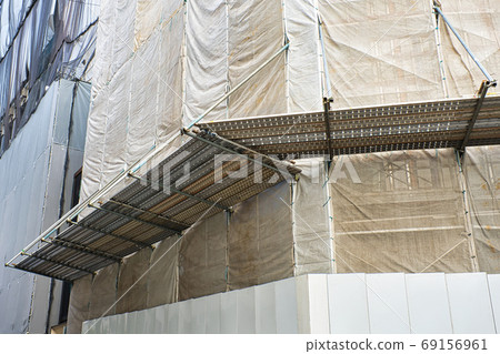 Morning glory and protective sheeting at a construction site 69156961