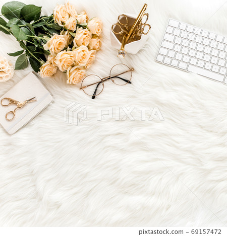 Female workspace with computer, roses flowers bouquet, golden accessories, diary, laptop, glasses on white background. Flat lay women's office desk. 69157472