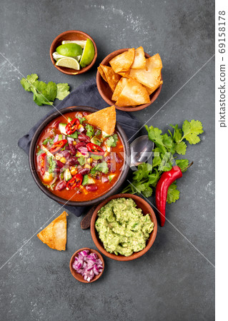 Mexican food concept background with chile black bean soup, guacamole and nachos totopos. Top view 69158178
