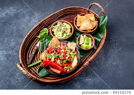 Mexican black bean soup with homemade fried tortillas totopos nachos served with guacamole 69158179