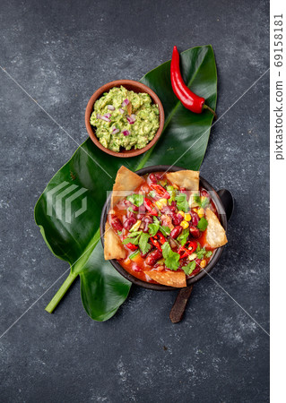 Mexican black bean soup with homemade fried tortillas totopos nachos served with guacamole Mexican black bean soup with homemade fried tortillas totopos nachos served with guacamole 69158181