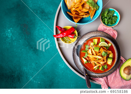 Mexican style table with spicy aztec soup with tortilla. Copy space 69158186