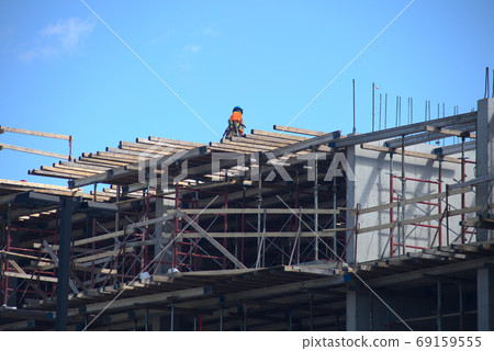 construction site structure worker on metal beams 69159555