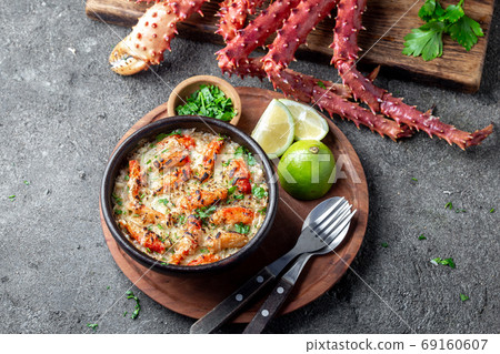 Chilean food. Baked crabmeat crab meat with cheese, cream and bread. Pastel o chupe de sentolla or king crab Chilean food. Baked crabmeat crab meat with cheese, cream and bread. Pastel o chupe de sentolla or king crab 69160607