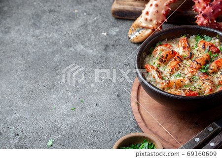Chilean food. Baked crabmeat crab meat with cheese, cream and bread. Pastel o chupe de sentolla or king crab Chilean food. Baked crabmeat crab meat with cheese, cream and bread. Pastel o chupe de sentolla or king crab 69160609