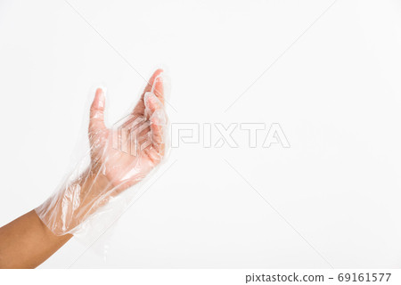 Woman hand wearing single use protect disposable transparent pla Woman hand wearing single use protect disposable transparent pla 69161577