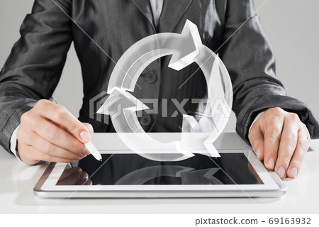 Female hands using graphics tablet and glass icons fly in air. Mixed media Female hands using graphics tablet and glass icons fly in air. Mixed media 69163932