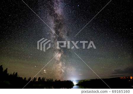 Milky Way and Stars Glowing during a Night Sky. Milky Way and Stars Glowing during a Night Sky. 69165160