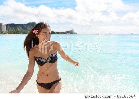 Hawaii woman in bikini swimming on Hawaiian beach Hawaii woman in bikini swimming on Hawaiian beach 69165564