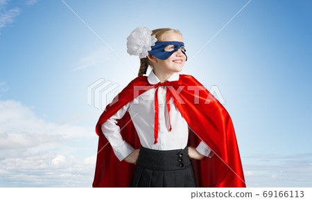 Girl power concept with cute kid guardian against sky background Girl power concept with cute kid guardian against sky background 69166113